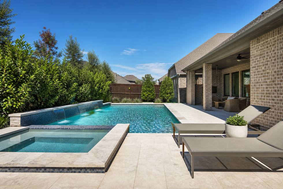 Grapevine modern pool with spa ledge and privacy landscaping