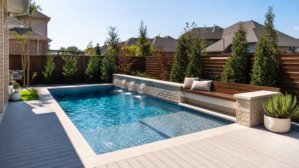 Compact backyard pool with bench seating and efficient decking